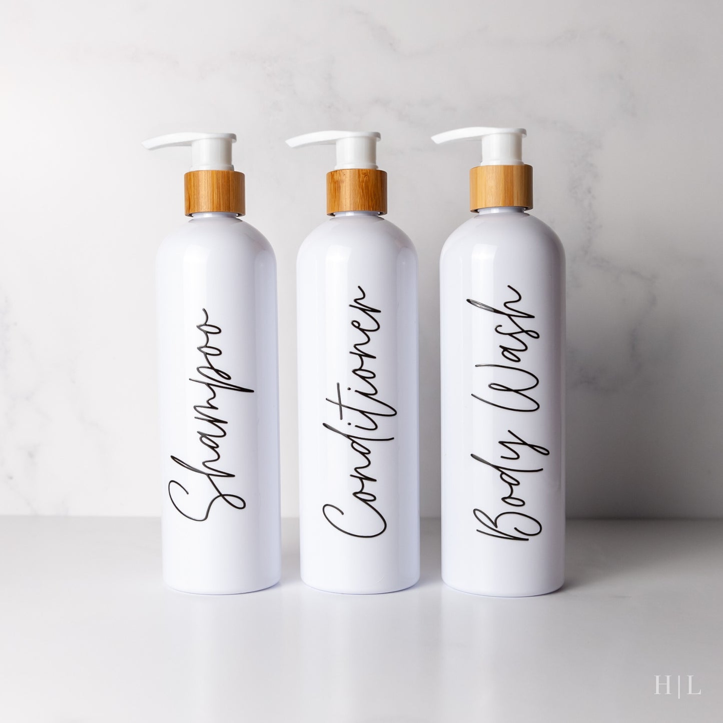 three bottles of personalized hand lotion on a counter
